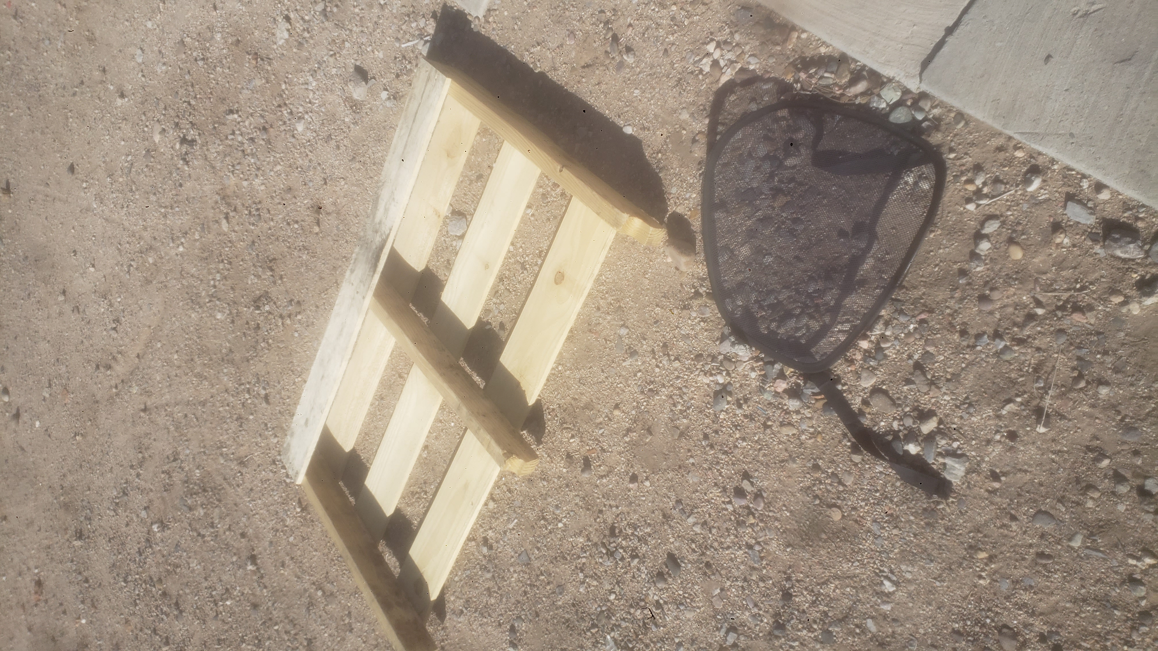 Upside down pallet on the ground.